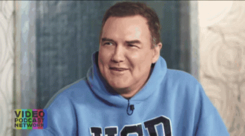 A Man Wearing A Blue Sweatshirt With The Word Titan On The Front GIF
