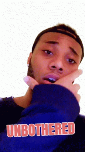 A Man Wearing A Blue Sweatshirt With The Word Unbothered On It GIF
