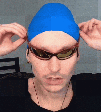 A Man Wearing A Blue Swim Cap And Sunglasses Adjusts His Sunglasses GIF