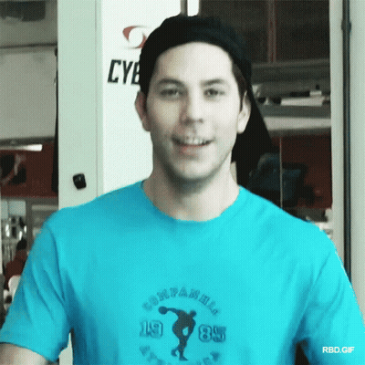 A Man Wearing A Blue T-Shirt That Says Companions 1985 GIF