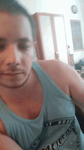 A Man Wearing A Blue Tank Top That Says ' Narrow ' On It GIF