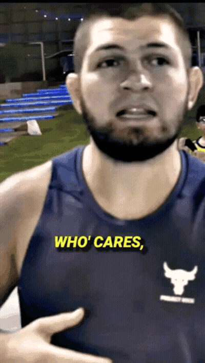 A Man Wearing A Blue Tank Top That Says Who Cares On It GIF