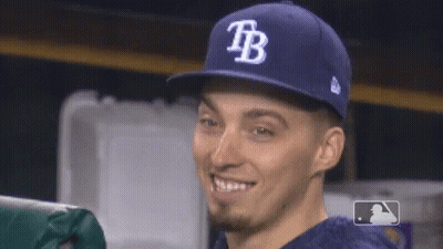 A Man Wearing A Blue Tb Hat Smiles GIF