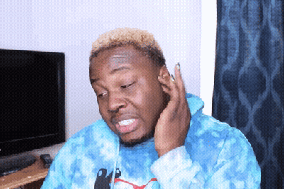 A Man Wearing A Blue Tie Dye Puma Sweatshirt Is Making A Funny Face GIF