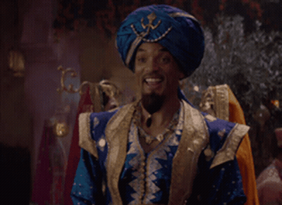 A Man Wearing A Blue Turban And A Blue And Gold Outfit Is Smiling GIF