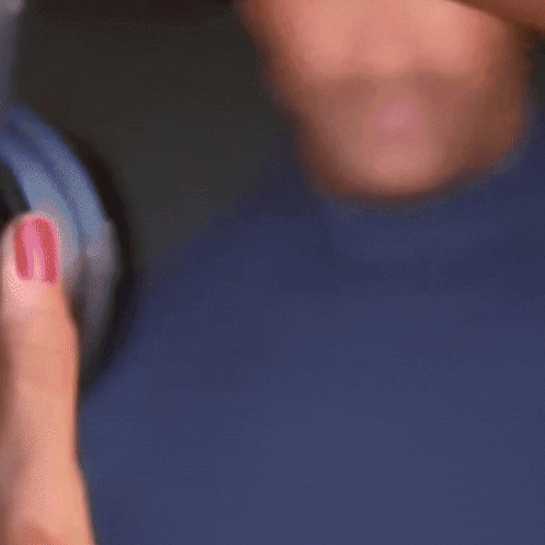 A Man Wearing A Blue Turtleneck Sweater Is Waving GIF