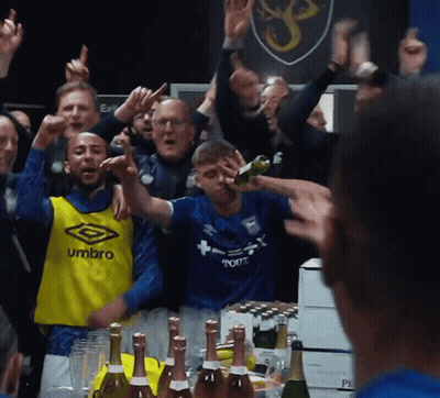 A Man Wearing A Blue Umbro Jersey Stands In Front Of A Crowd GIF