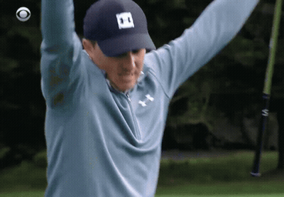A Man Wearing A Blue Under Armour Shirt Is Holding A Golf Club In His Hands GIF
