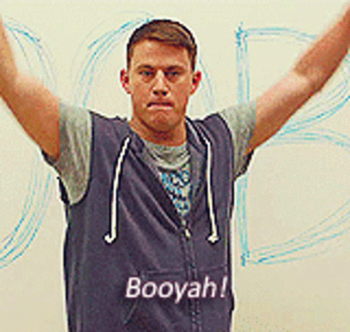 A Man Wearing A Blue Vest That Says Booyah GIF