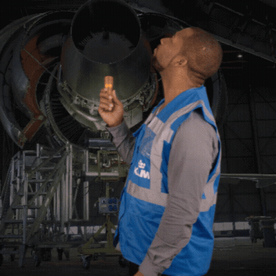 A Man Wearing A Blue Vest That Says Klm On The Front GIF