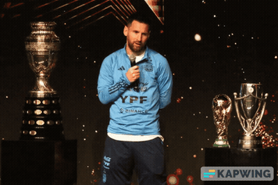 A Man Wearing A Blue Ypf Shirt Stands In Front Of A Microphone GIF