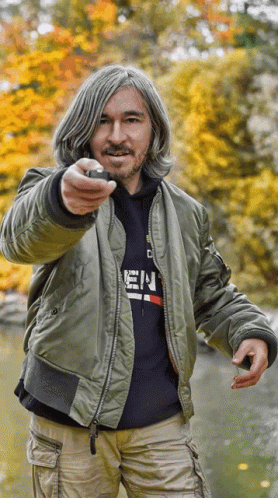 A Man Wearing A Bomber Jacket And A Hoodie That Says ' E.n. ' On It GIF