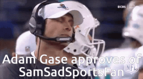 A Man Wearing A Bose Headset Watches A Football Game . GIF
