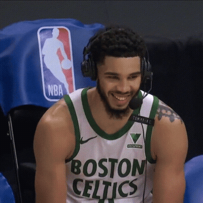 A Man Wearing A Boston Celtics Jersey Is Smiling GIF