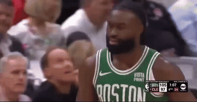 A Man Wearing A Boston Jersey Stands In Front Of A Crowd During A Basketball Game GIF