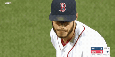 A Man Wearing A Boston Red Sox Hat Looks Down At Something GIF
