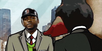 A Man Wearing A Boston Red Sox Hat Talks To Another Man In A Suit GIF