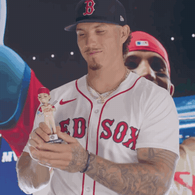 A Man Wearing A Boston Red Sox Jersey Holds A Baseball Figure GIF