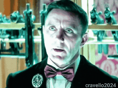 A Man Wearing A Bow Tie And A Pin With The Name Cravello2024 GIF