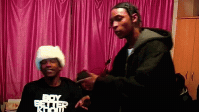 A Man Wearing A Boy Better Know T-Shirt Stands Next To Another Man GIF