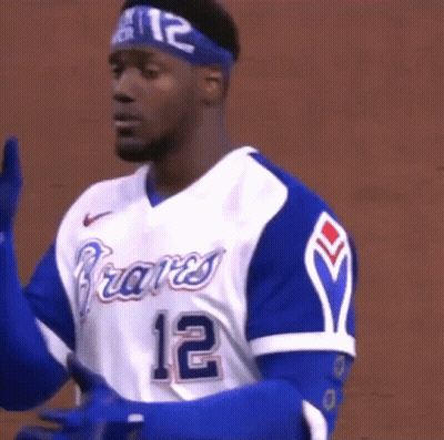 A Man Wearing A Braves Jersey And Gloves GIF