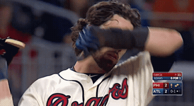 A Man Wearing A Braves Jersey Covers His Eyes GIF