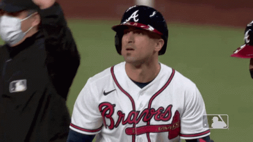 A Man Wearing A Braves Jersey Stands On A Field GIF