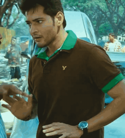 A Man Wearing A Brown And Green Polo Shirt With A Yellow Eagle On It GIF