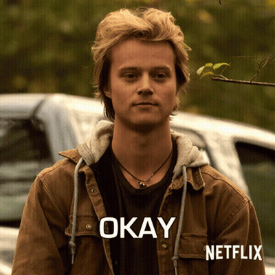 A Man Wearing A Brown Jacket With The Word Okay Written On It GIF