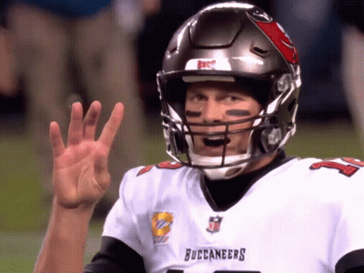 A Man Wearing A Buccaneers Jersey Is Waving GIF