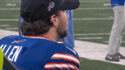 A Man Wearing A Buffalo Bills Jersey Looks To The Side GIF
