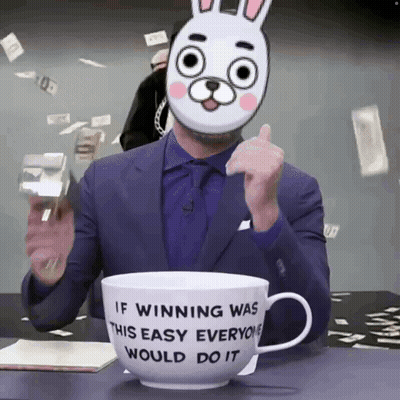 A Man Wearing A Bunny Mask Is Sitting In Front Of A Cup That Says If Winning Was This Easy Everyone Would Do It GIF