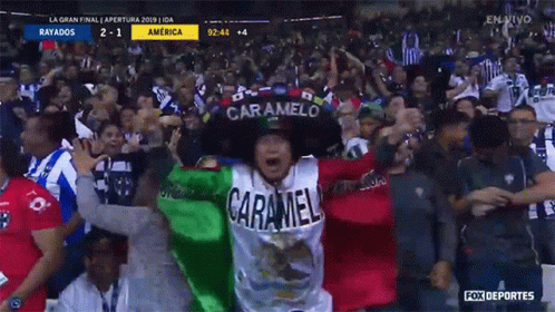 A Man Wearing A Caramelo Hat Stands In A Crowd At A Soccer Game GIF