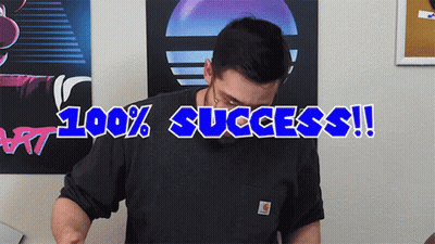 A Man Wearing A Carhartt Shirt Stands In Front Of A Poster That Says 100 % Success GIF