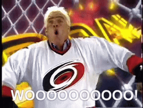 A Man Wearing A Carolina Hurricanes Jersey Is Celebrating A Goal GIF
