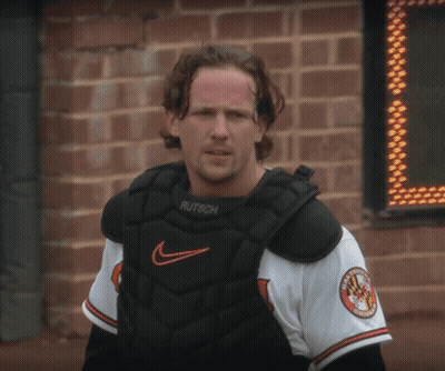 A Man Wearing A Catcher 'S Chest Protector With The Word Rutsch On It GIF