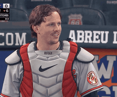A Man Wearing A Catcher 'S Vest That Says Rutsch GIF