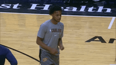 A Man Wearing A Cavaliers Shirt Stands On A Basketball Court GIF