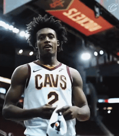 A Man Wearing A Cavs Jersey Holds A Hat GIF