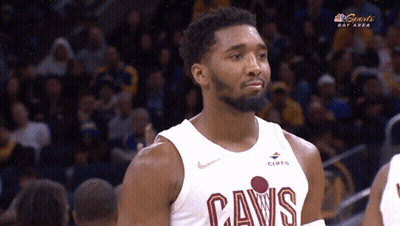 A Man Wearing A Cavs Jersey Looks At Something GIF
