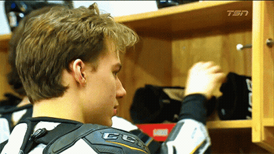 A Man Wearing A Ccm Shoulder Protector Looks Into A Closet GIF