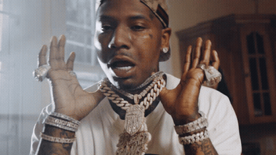 A Man Wearing A Chain Around His Neck And Many Bracelets GIF