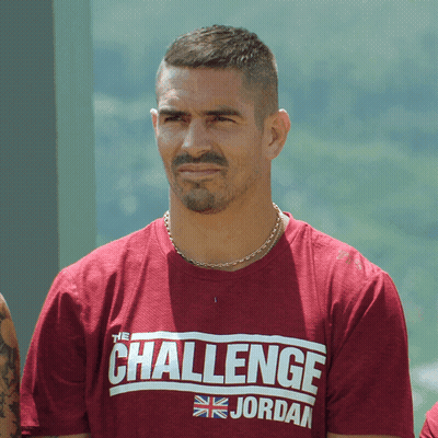A Man Wearing A Challenge Jordan Shirt Looks At The Camera GIF