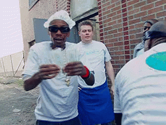 A Man Wearing A Chef 'S Hat And Sunglasses Is Standing In Front Of A Brick Wall GIF