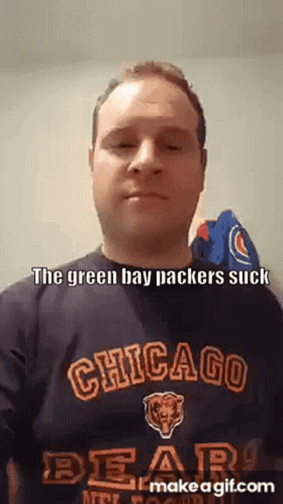 A Man Wearing A Chicago Bears Shirt Is Making A Funny Face . GIF