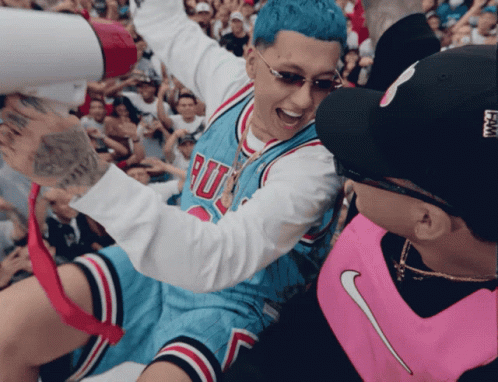 A Man Wearing A Chicago Bulls Jersey Is Being Lifted By A Man Wearing A Pink Nike Vest GIF