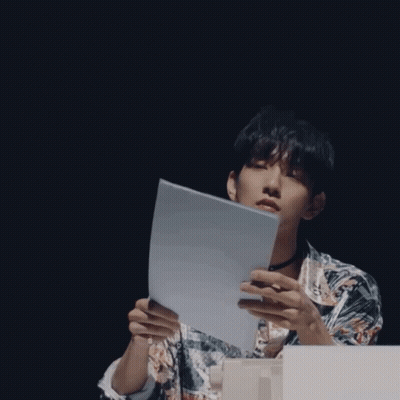 A Man Wearing A Choker And A Shirt With The Letter E On It GIF