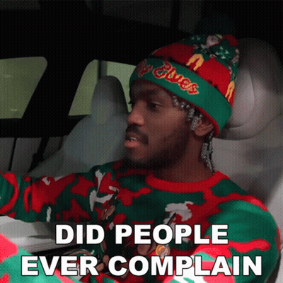 A Man Wearing A Christmas Sweater And A Beanie Says Did People Ever Complain GIF