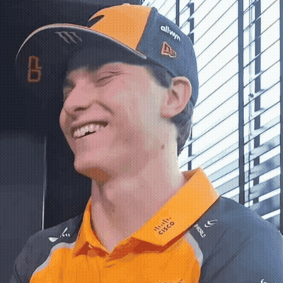 A Man Wearing A Cisco Shirt And A Hat Is Smiling GIF