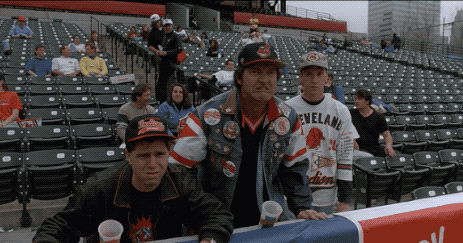 A Man Wearing A Cleveland Jersey Stands In A Crowded Stadium GIF